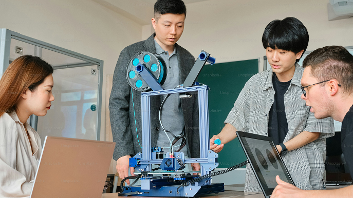 Students working with a 3D printer